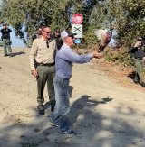 Kings County Sheriff Dave Robinson and farming magnate John Vidovich release pheasants recently as part of a county inmate program.